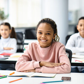 young youth sitting at desks